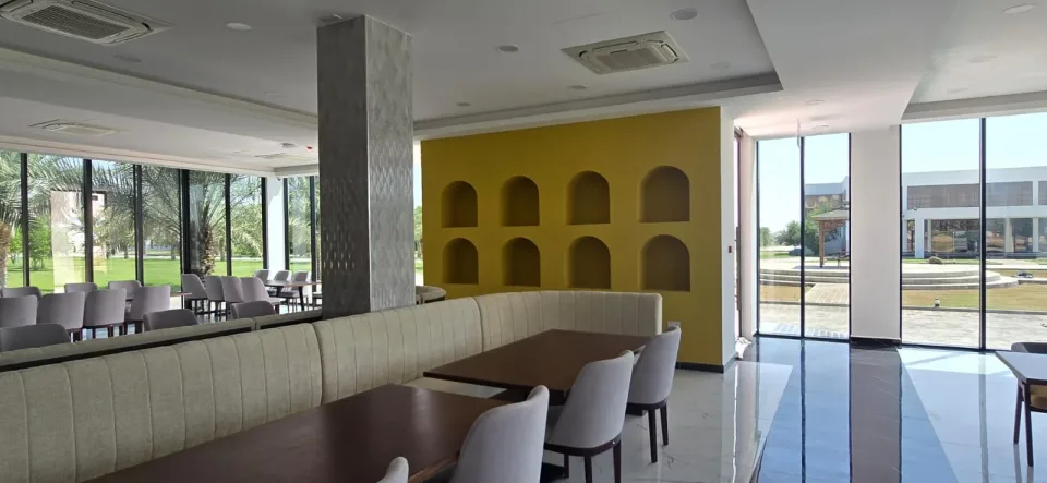 Booth seating beside the wall of Omani arches