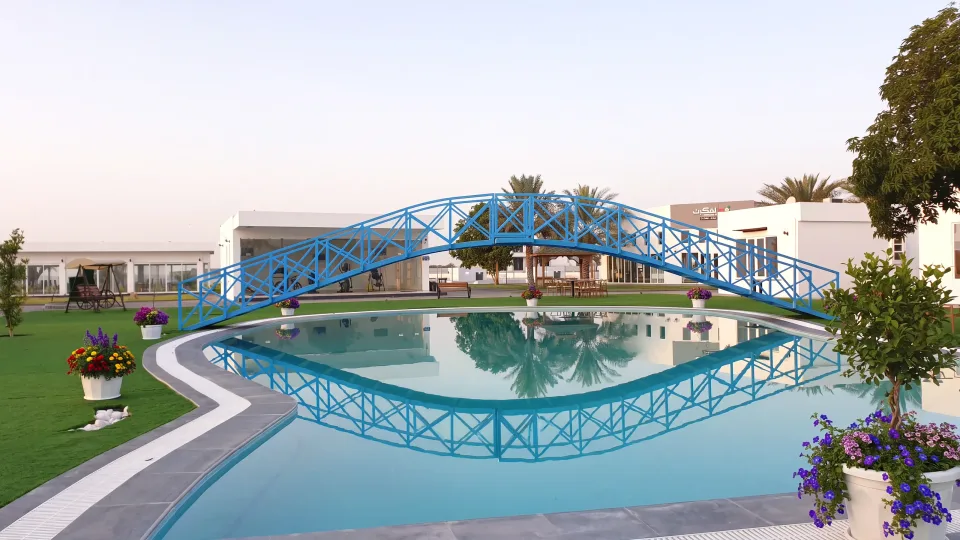 The blue footbridge over the pool