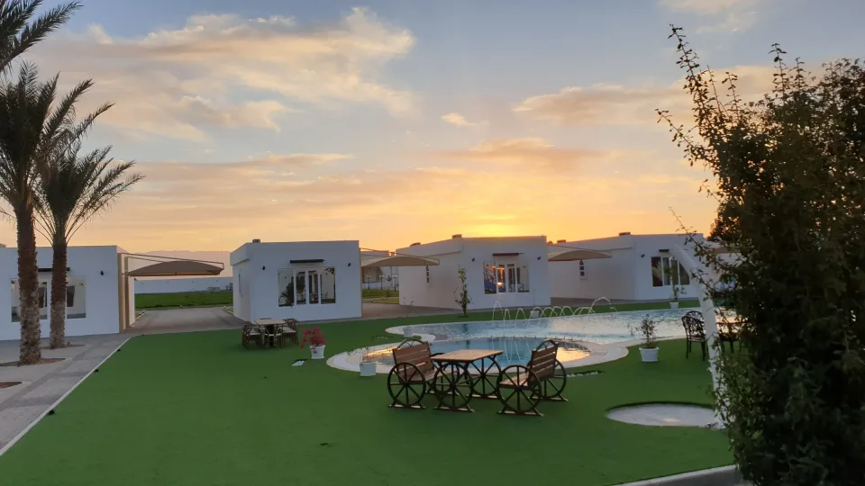 Villas and pool at dusk