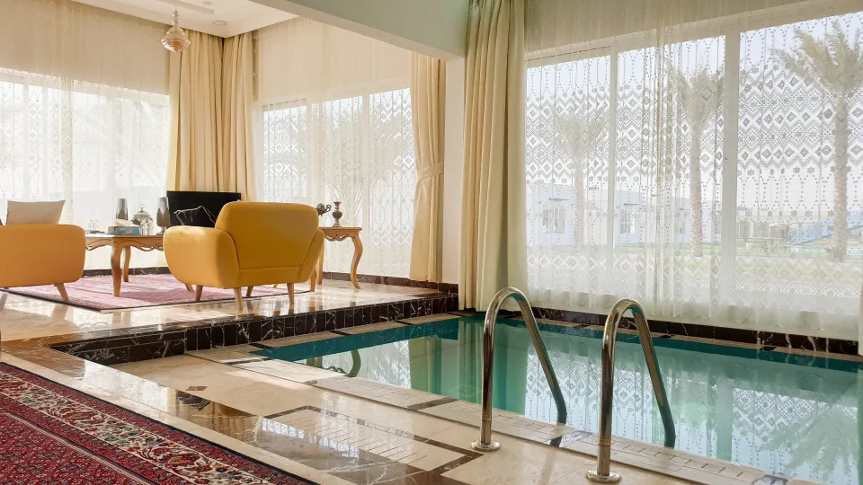A villa lounge beside its private pool